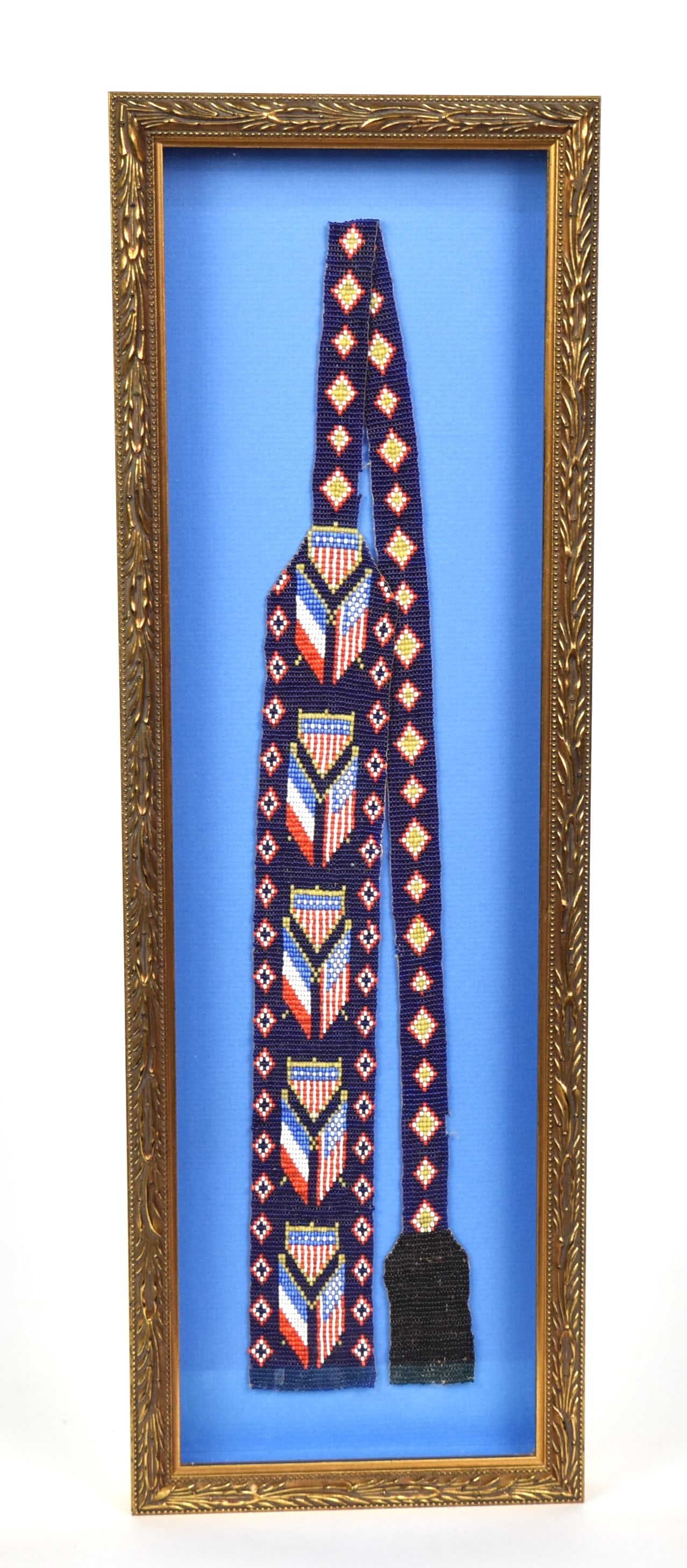 Native American Loom Beaded Belt: Decorated with French tri-color & U.S. crossed flags with U.S. shield above in red, white, blue greasy yellow and black beads, 37" long, framed in gilt shadow-box frame, 7 1/2 x 22 1/2" high. Conditio