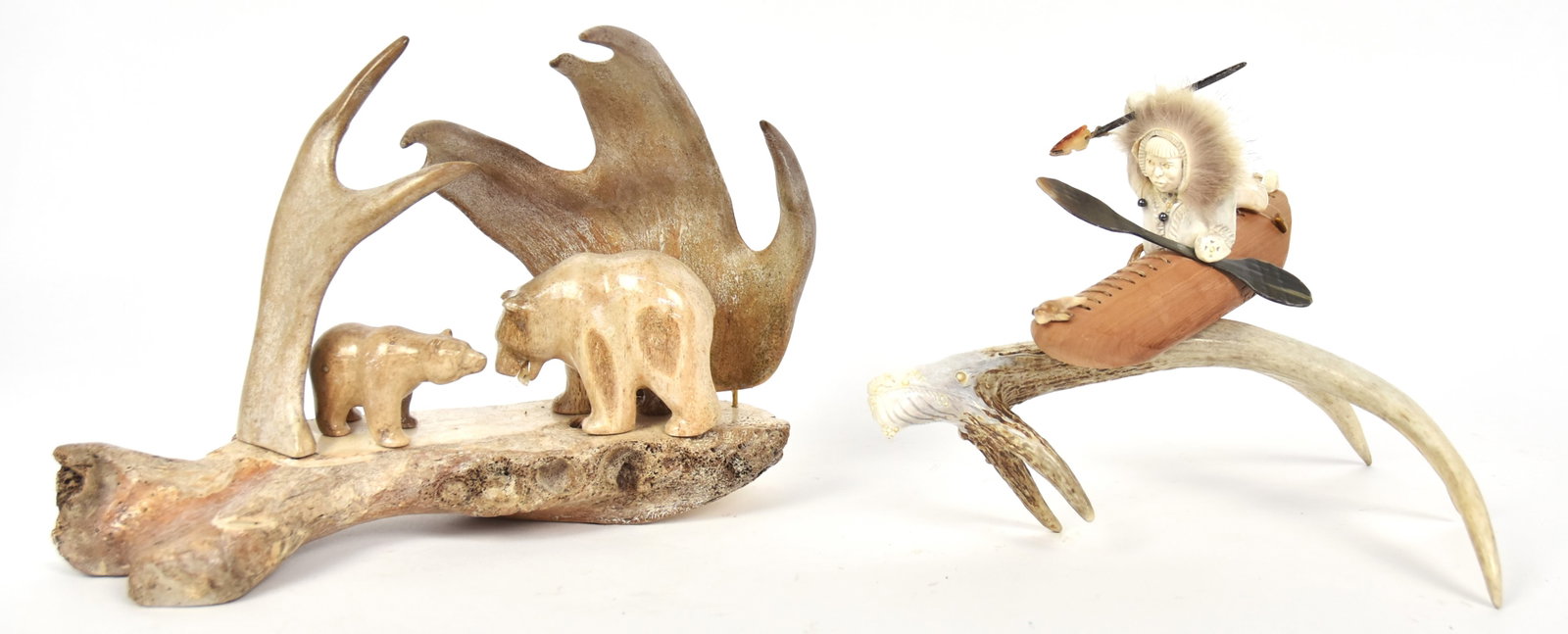Two Fine Inuit Carvings: Including an outstanding carved fossilized whale bone and caribou antler of two polar bears on ice flow with mother having MOP fish in mouth, signed E.G. in ink on underside, 11 x 5 x 8" high; and Inu
