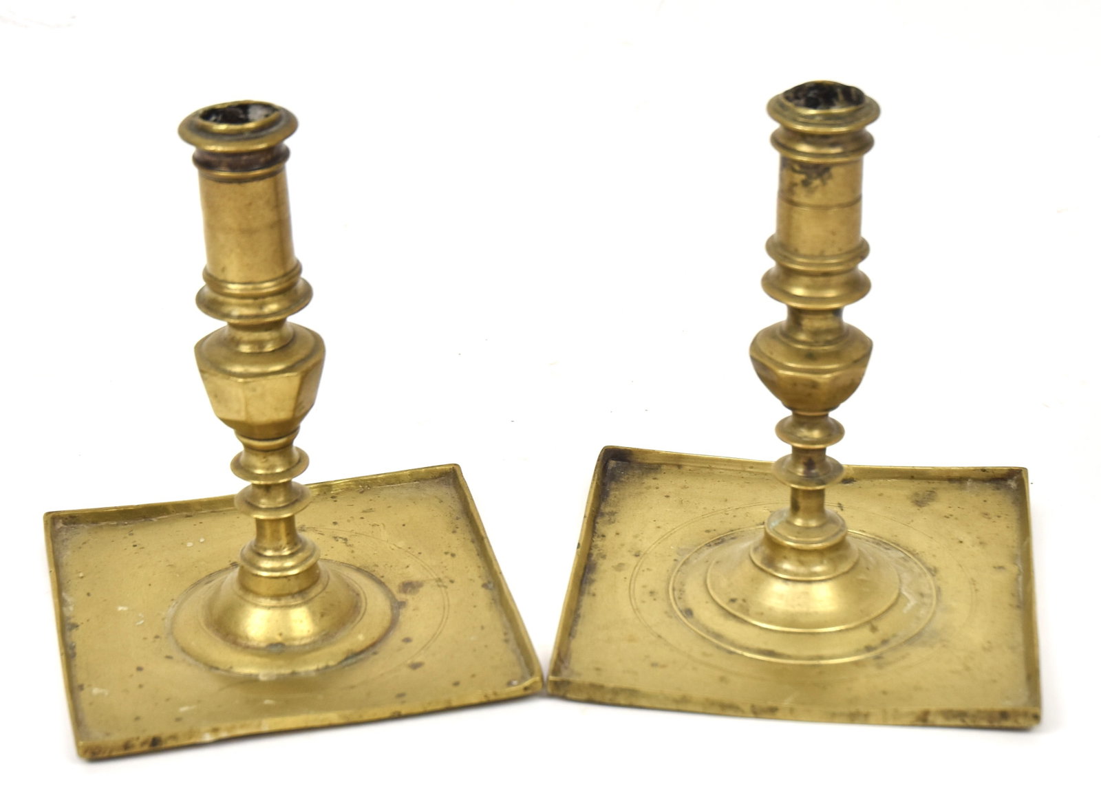 Pair Queen Anne Brass Candlesticks: Mid 18th century with square drip pan base and turned & hextagon column, nice old patina, 5 1/4" square x 6 1/2" high. Condition VG.