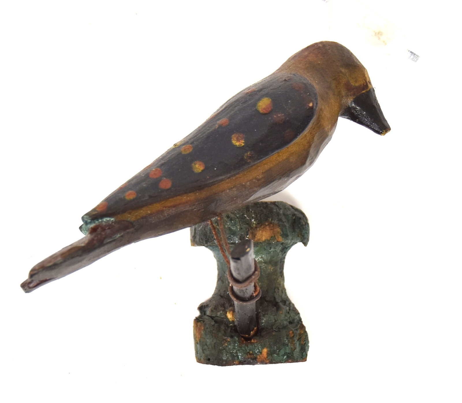 Painted Wood Folk Art Bird on Branch: Polychrome painted with yellow body, green wings with red & yellow dots, red tail and black beak, pin head eyes, perched on twig branch, which is mounted on turned wall mount, in green paint, 5 x4 1/4