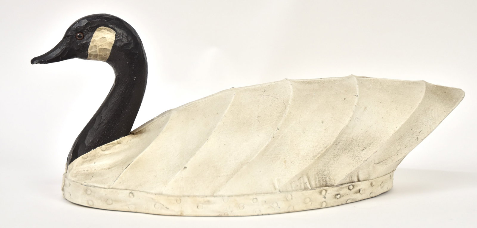 Canada Goose Decoy: Early canvas covered body with wood head and glass eyes, old repaint signed on wood base Currimak Sause?, 9 x 23 x 9" high. Condition As above, VG.