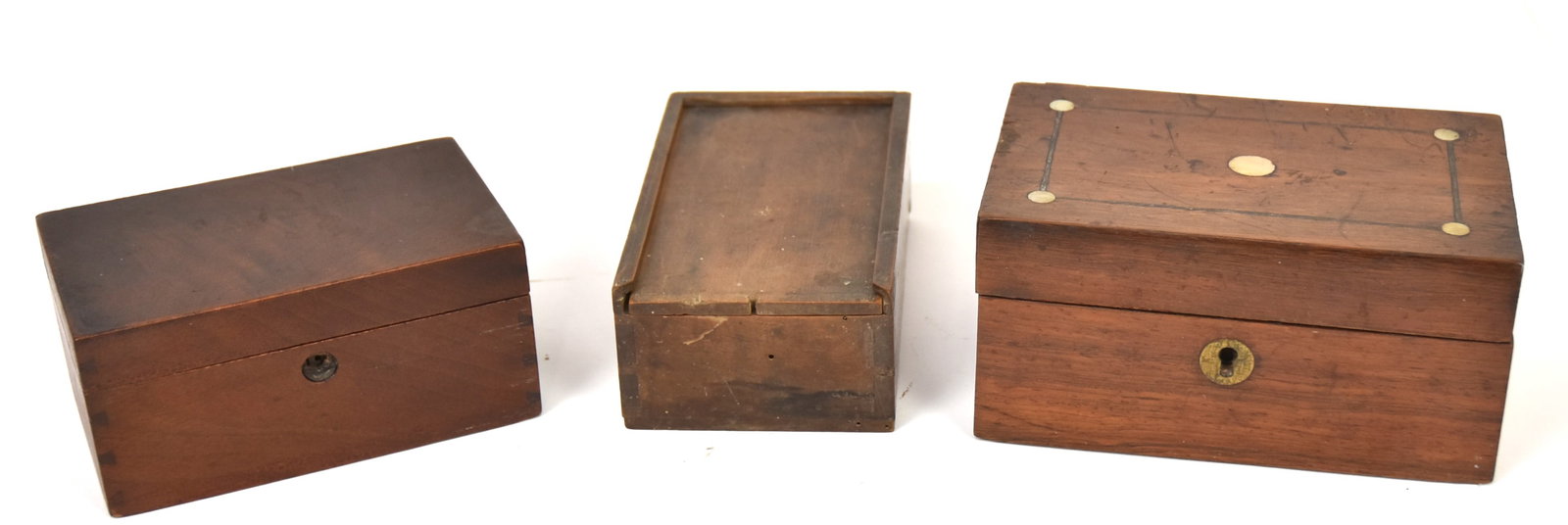 Three Early Small Wood Boxes: Including a dovetailed coin/cask box with divided interior and sliding lid in maple with fine patina and inked inscritption on base in German, 3 3/4 x 6 x 2 1/4" high; plus dovetailed burled walnut wi