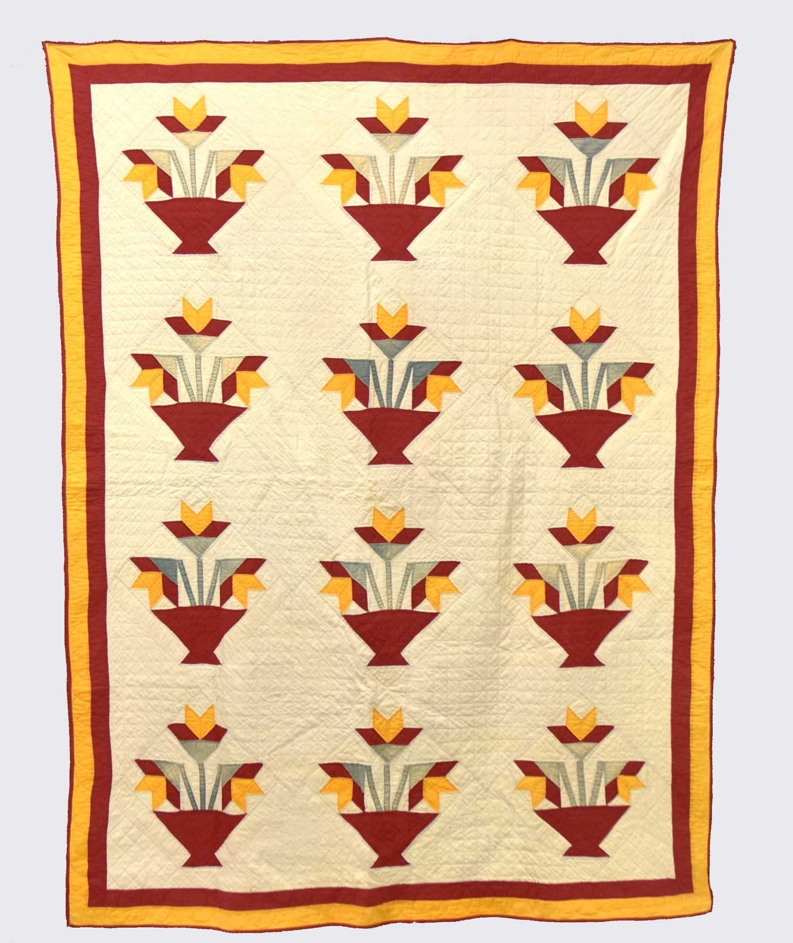 Early Appliqued Quilt: Tulip Basket pattern with three rows of four baskets in red, yellow and green fabric, all hand quilted, 58 x 78". Condition VG+.