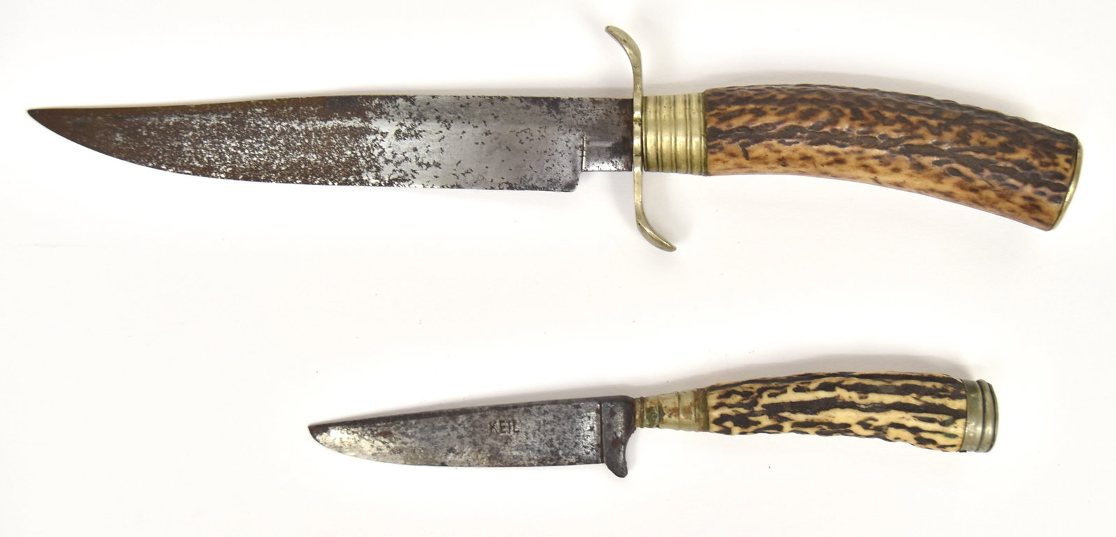Two Early Bowie Knives: Both with antler grips, larger likely American with 6" single edge steel blade, S form nickel guard and 1/2" nickel collar with nickel pommel, total length 10 1/4"; and likely Sheffield example with u