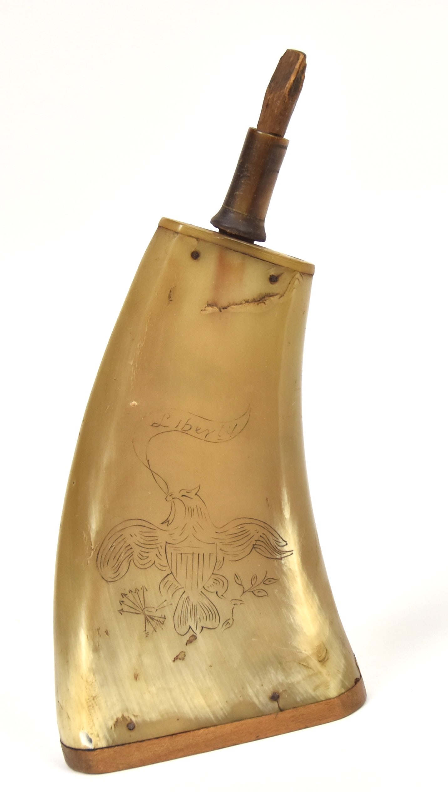 Scrimshaw Powder Horn: Flat sided engraved with U.S. Shield breasted spread winged eagle, clutching ribbon banner in beak with Liberty and arrows and laurel brnch in talons, woof plug end with name Destner, horn spout and w