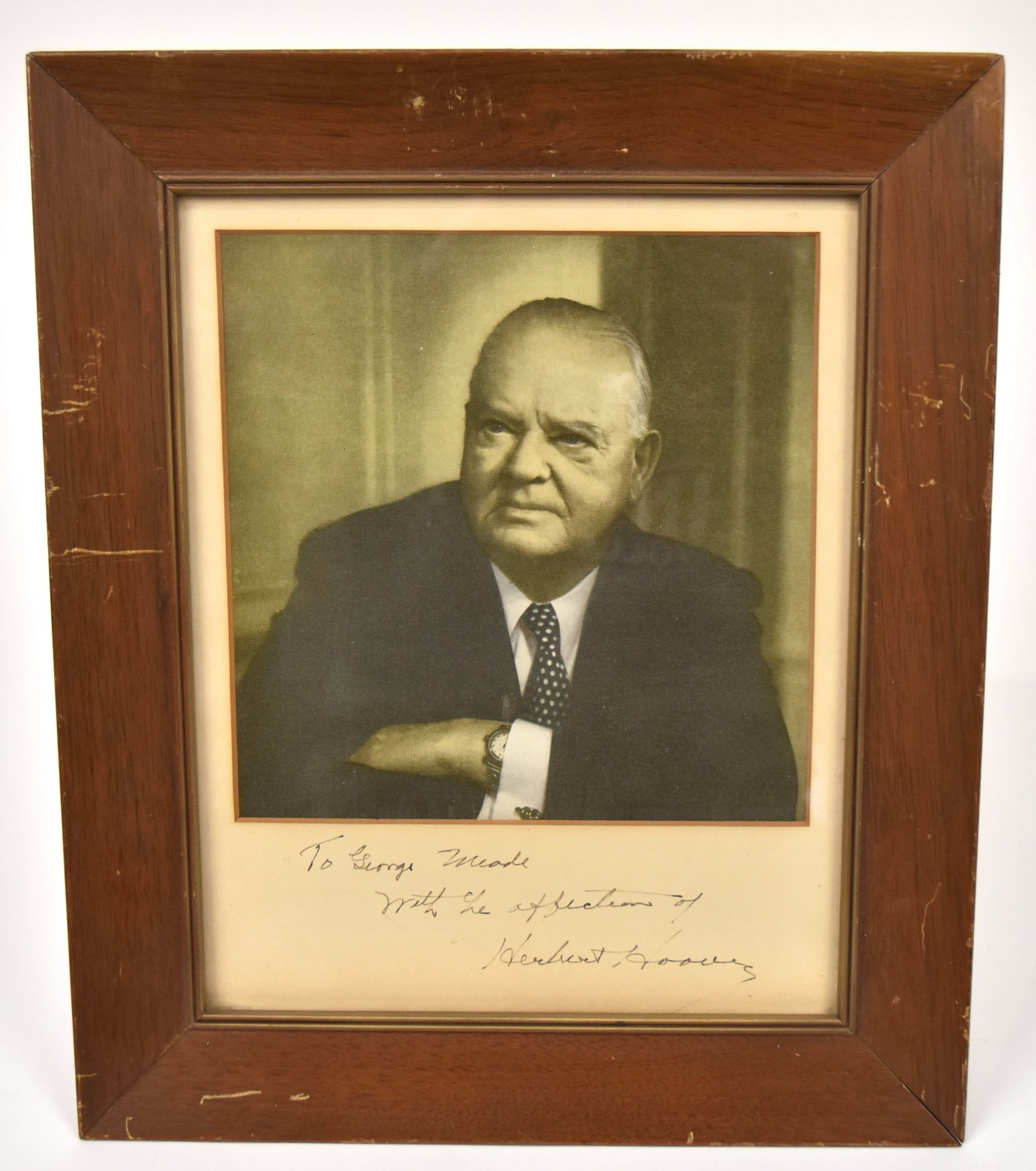 Herbert Hoover Autographed Photo: Matted half length photograph of Hoover with matt signed in ink reading: to George Meade With the affection of Herbert Hoover, in original walnut frame, 10 1/2 x 12 1/2". Condition VG.