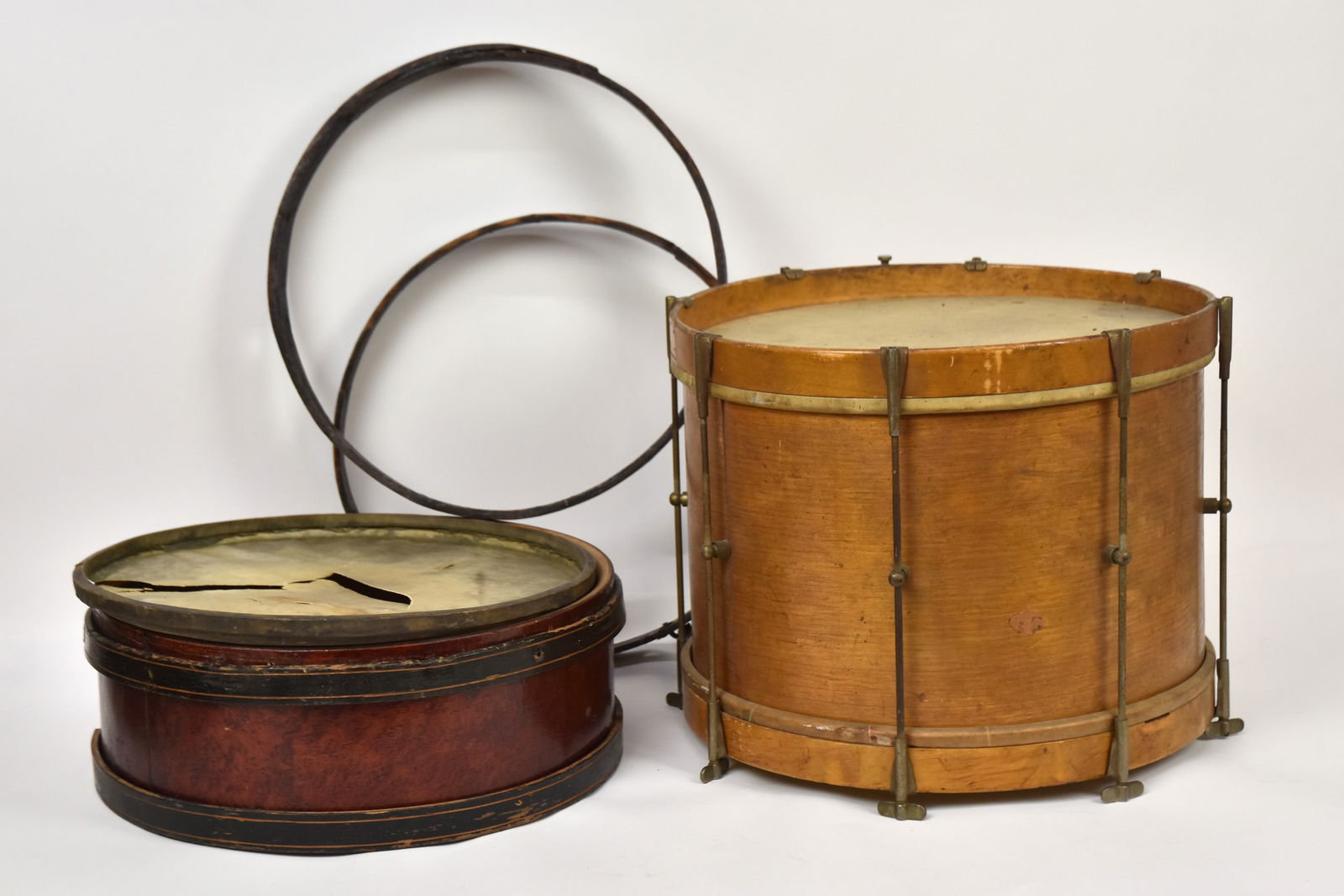 Early Drum & Parts: A 18" diameter bentwood drum with vellum heads, marked 20th Century Trade Mark, 14" high; and signed Rudolph Wurlitzer, Cincinnati, O. bentwood drum with two black painted bands, and polychrome painte