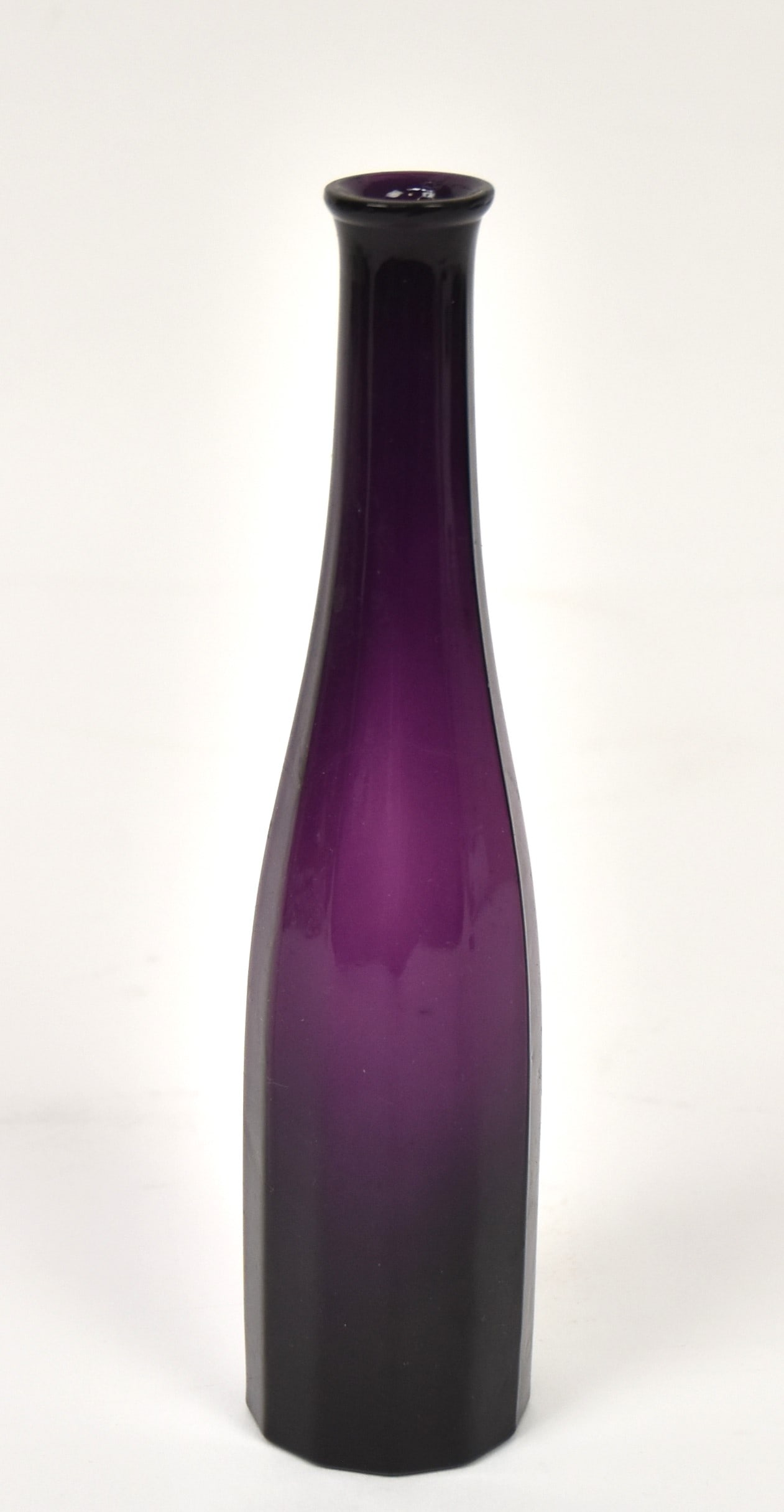 Early Blown Glass Paneled Bottle: Amethyst paneled bottle with tooled and fire polished lip, 1 3/4" diameter x 7 3/4" high. Old white inked museum accession number on base G137, Condition VG.