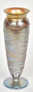 Victor Durand iridescent gold threaded & footed vase: Signed V Durand, 2011-10. 10”T. Minor thread loss & skips. Most possibly factory, due to the light application of the threads skimming the surface.