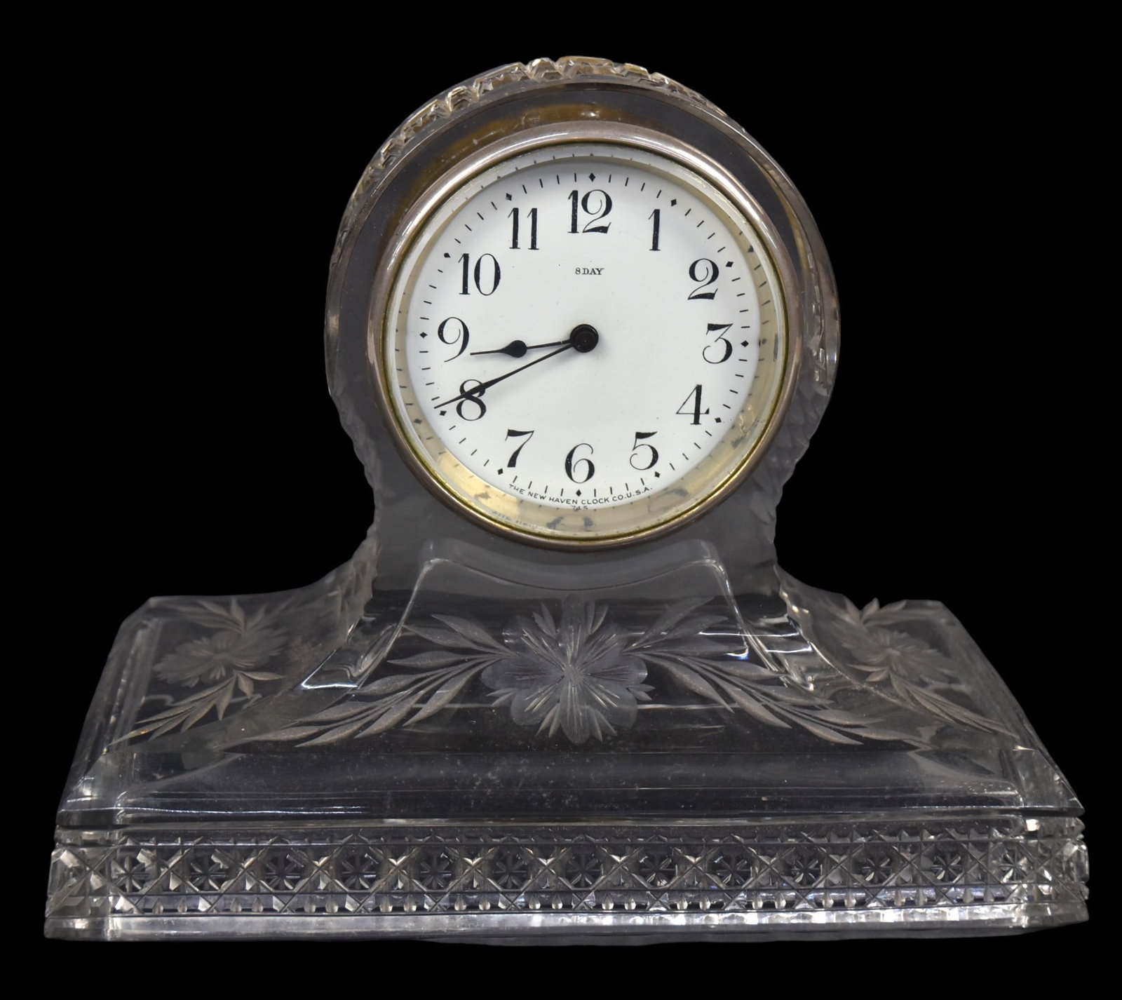 American Cut Gass Mantle Clock: Cut hobstars around base anddome with floral cutting on sides, New Haven 8-day time only spring driven brass movement, 9 3/4 x 5 x 7 3/4" high. Condition VG+.