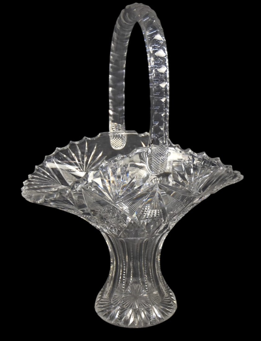 American Cut Glass Basket: Hobstar, fan, panel and nail head cutting with notched handle and sun burst base, saw tooth edge, 9 1/2 x 5 1/4 x 13 1/2" high. Condition VG+.