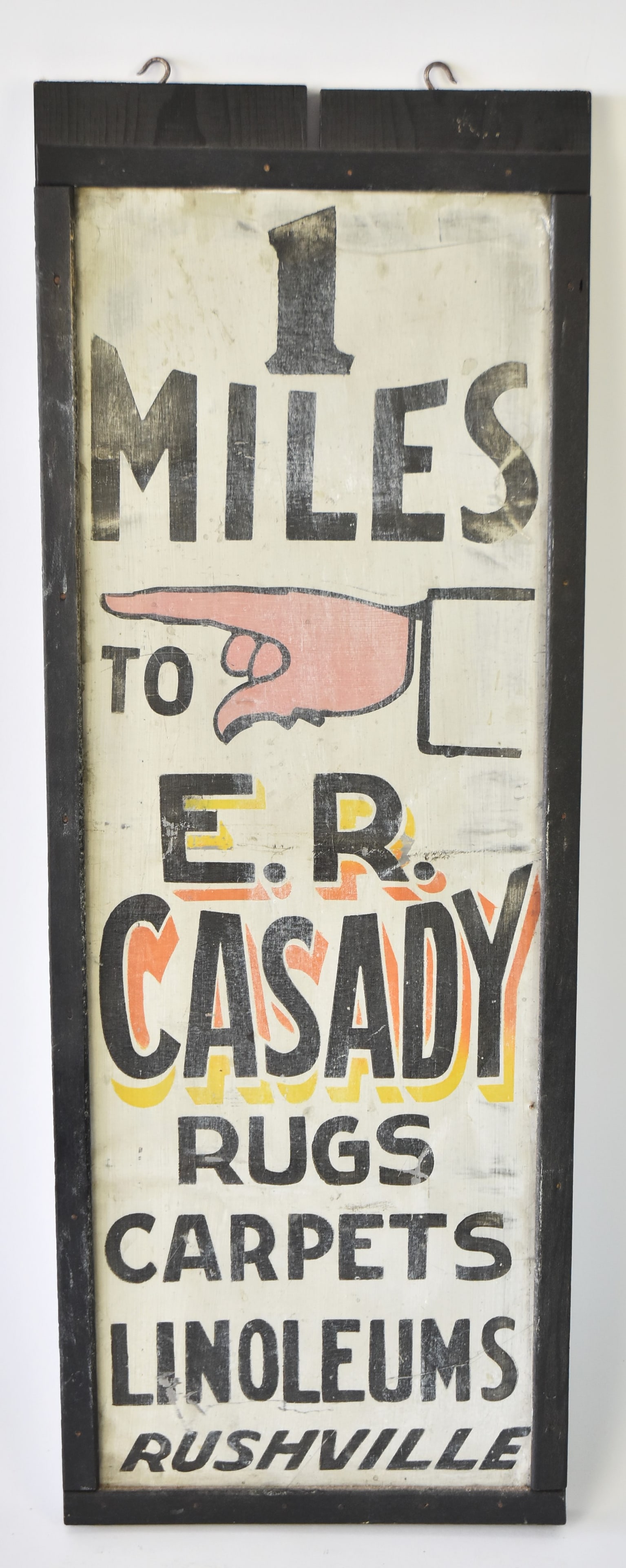 Early E.R. Casady Rug, Carpets Rushville Sign: Wood framed tin sign with pointing finger. 30 x 11.