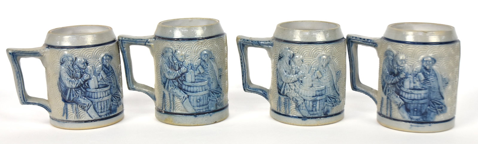Four Decorated Whites Utica Stoneware Mugs: Salt glaze with relief molded tavern scene on one side and standing Bison on the other, all decorated with cobalt, 4.5 x3.25 x4.5" high. Condition all Fine.