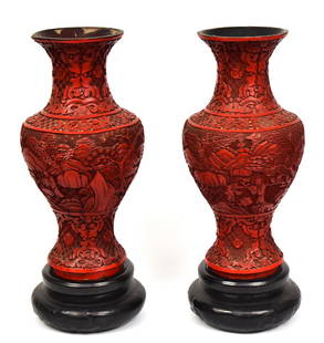 Pair Early Chinese Cinnabar Vases: Circa 1800-1850, beautifully carved baluster form with scenes of scholars and students in garden setting, 6" diameter x 12 1/2" high, includes black glazed ceramic bases, 6" diameter x 3" high. Condit