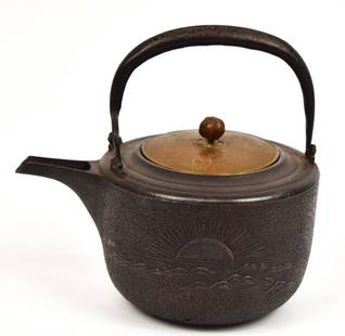 Edo Japanese Iron & Bronze Sake Kettle: Circa early 19th century with sun rising over ocean on one side and two rocks rising from sea with rope bridge between, applied hollow cast handle with inlaid bronze floral scroll on each side, lid in