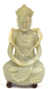 Chinese Jade Seated Buddha: Light green jade with open palms in lap on teak stand, 3 1/4 x 2 x 6 3/4" high. Condition, there is a very very small flake at the top of the crown in the front shown in photo, stand not original, res