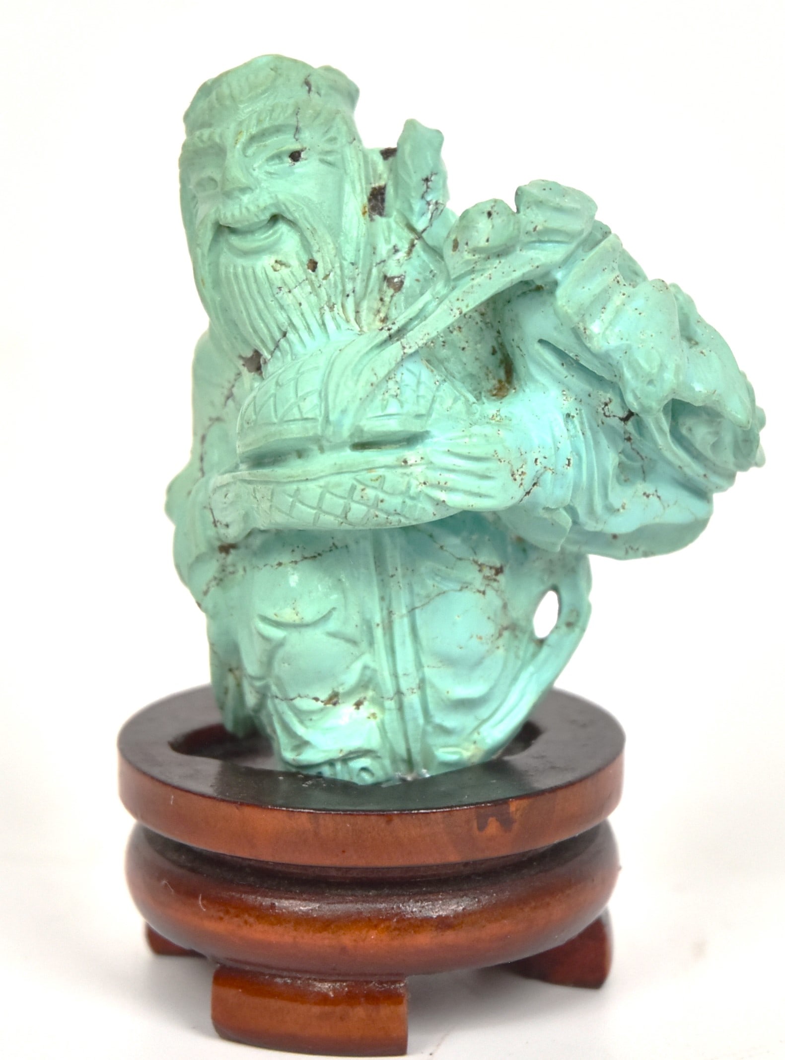 Chinese Turquoise Carving: Elderly gentleman with covered basket and flowers, mounted on teak stand, 3 1/4" high. Condition Fine.