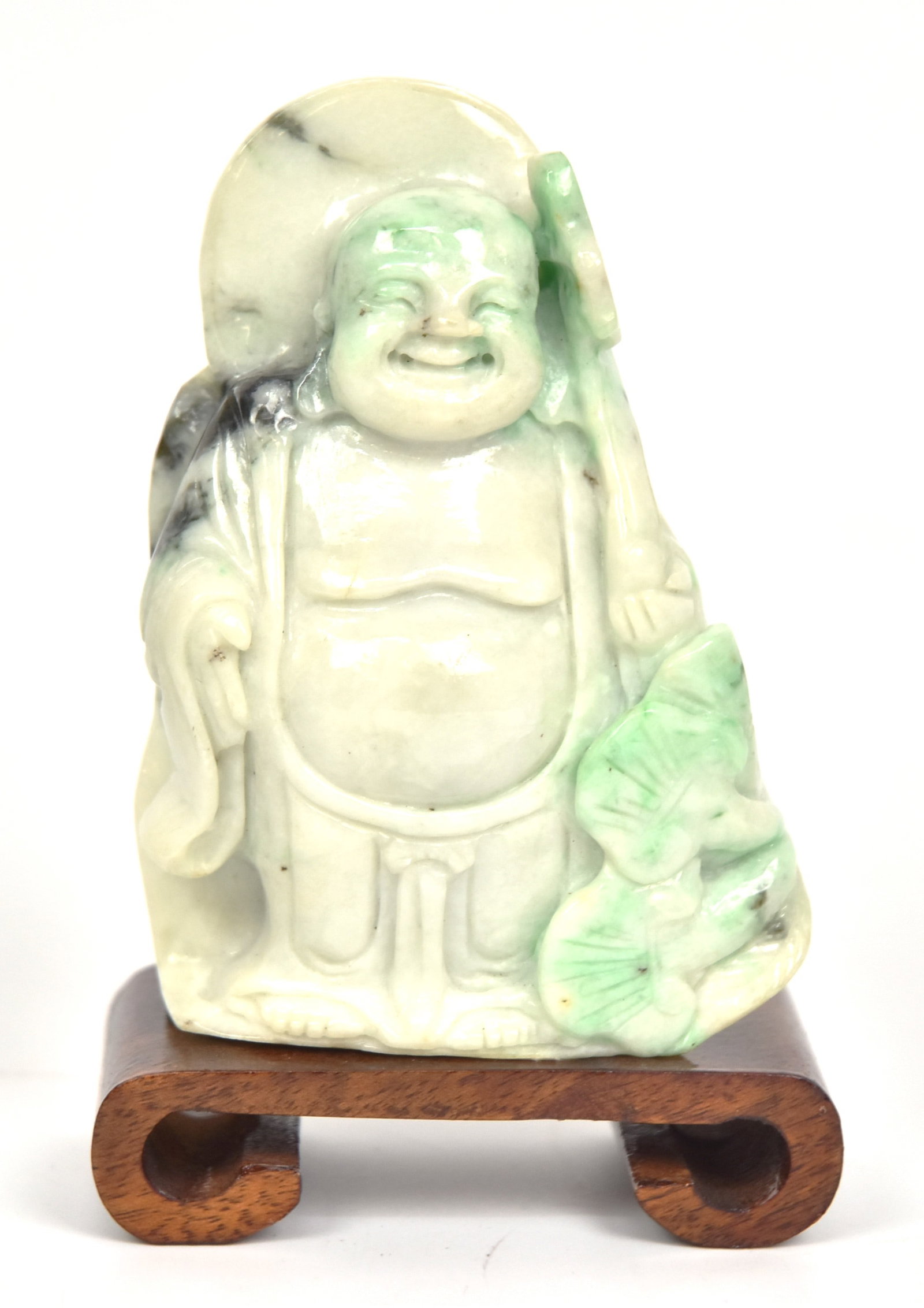 Chinese Carved Jade Buddha: Mottled light green, standing with lotus leaves and flowers, 4" high with " carved teak base. Condition Fine.