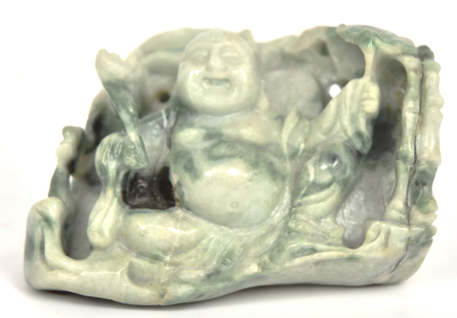 Chinese Carved Jade Buddha: Seated in floral grotto, mottled green, 4 1/4 x 3 12 x 2 3/4" high. Condition Fine.