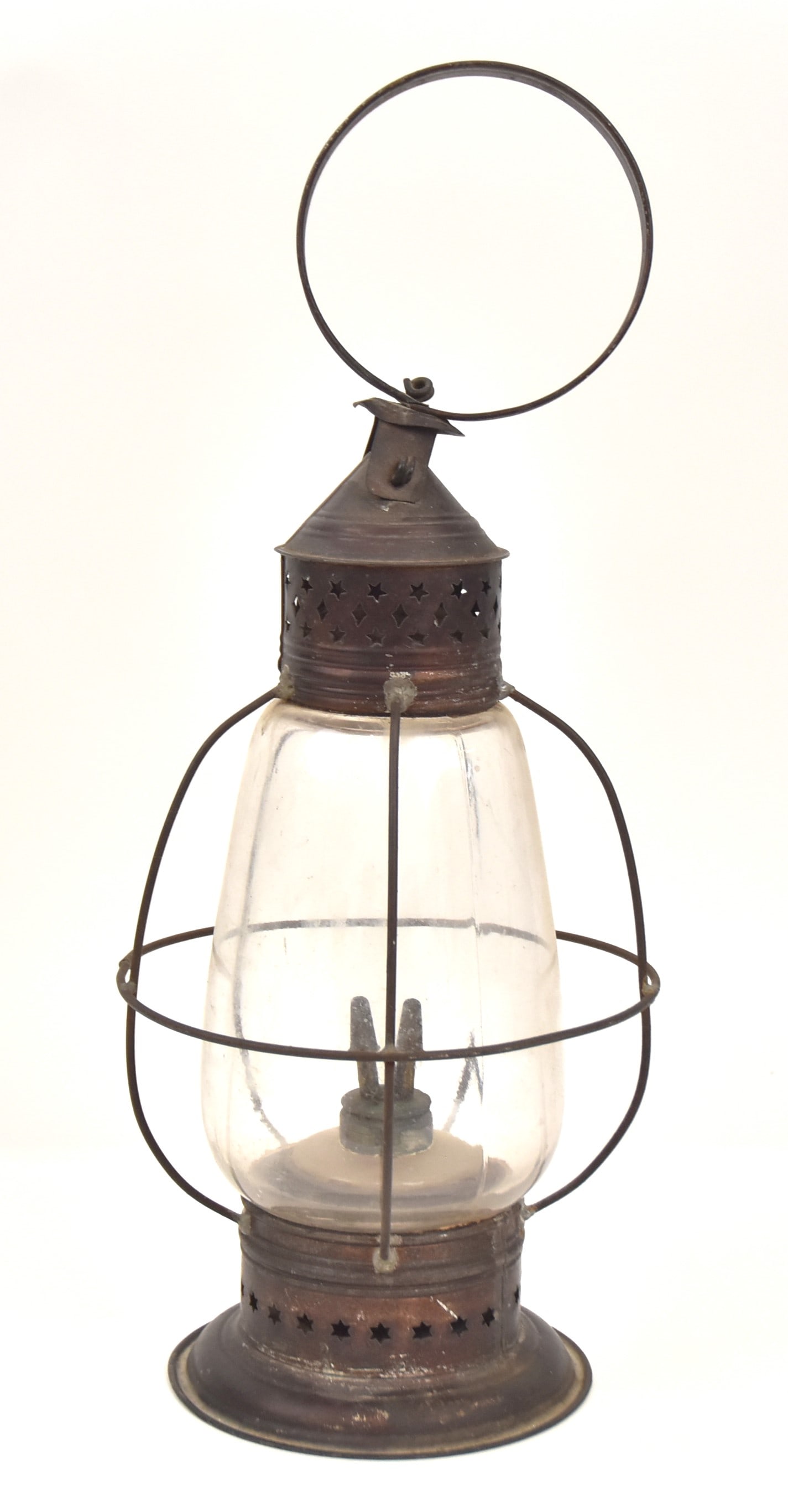 Early Tin Lantern: With loop handle at top, open star cutouts, glass globe, and glass font in tin removable holder at base. 17" H x 7" W. Good condition.