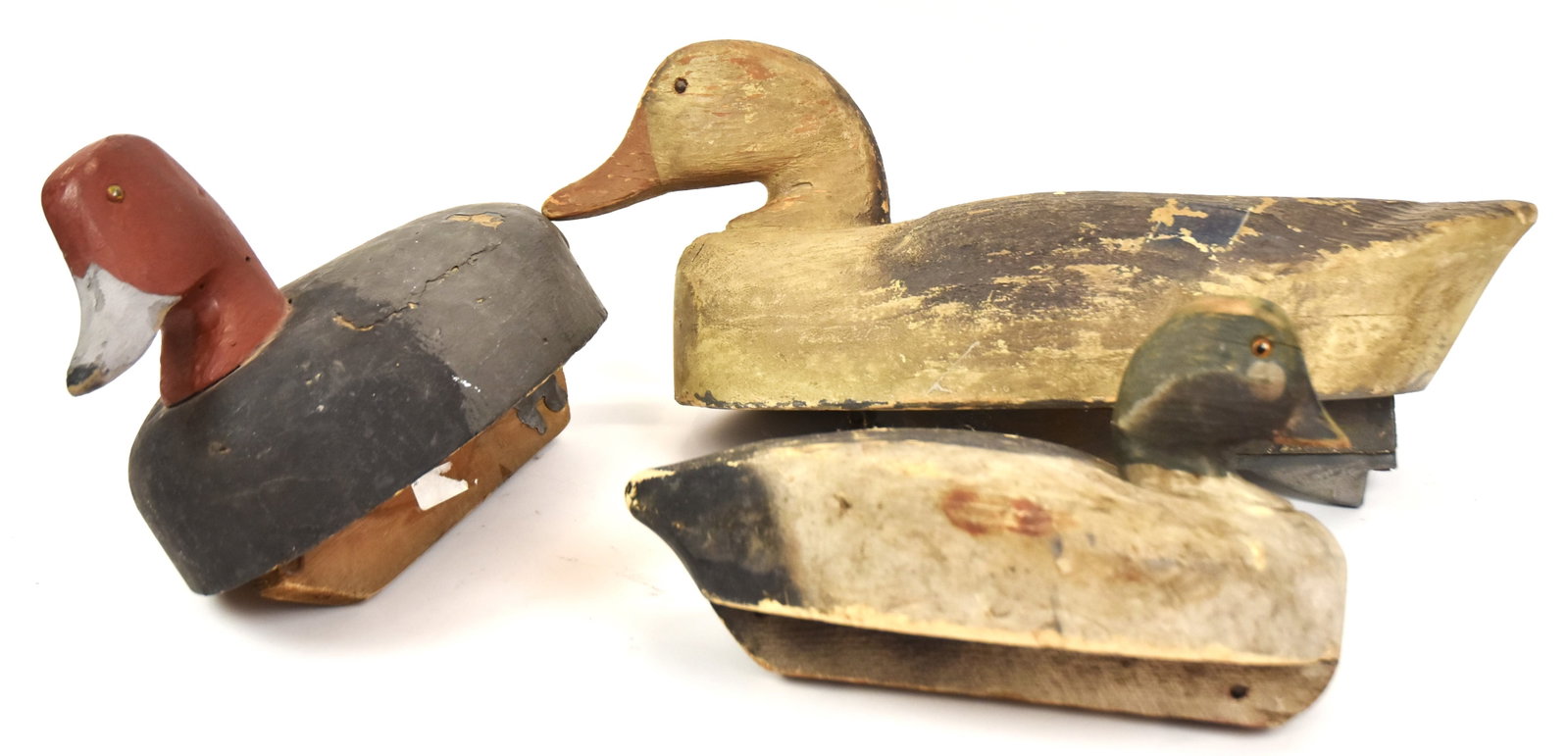 Three Wooden Duck Decoys: Old paint. Largest 8" H x 19" Long. Good condition.