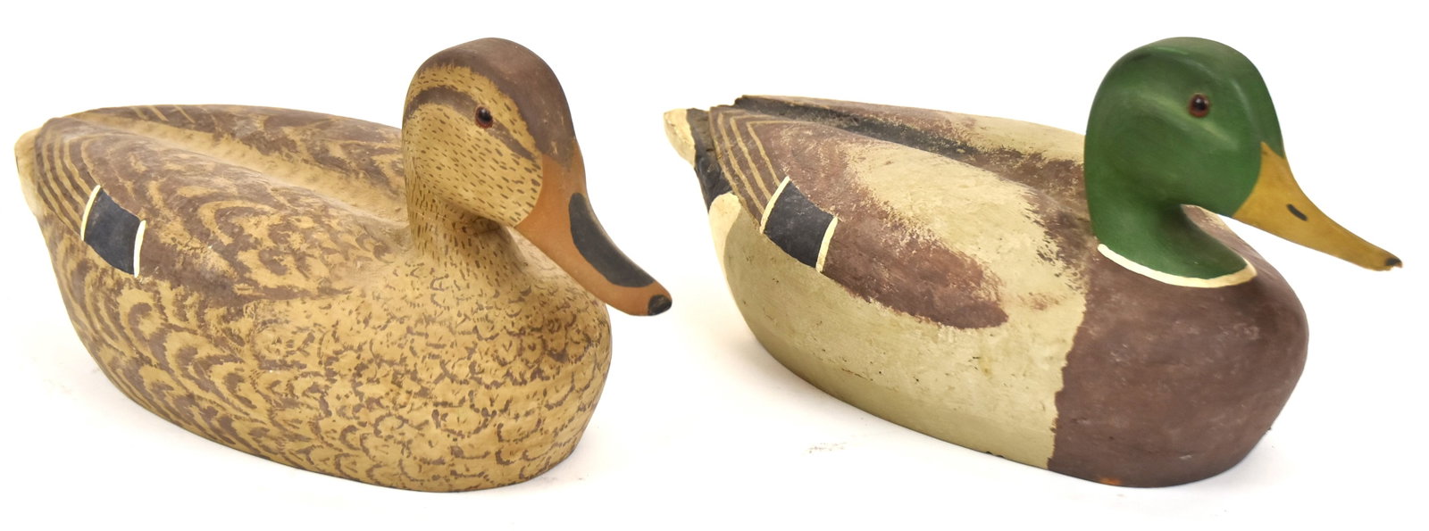 Pair of Mallard Duck Decoys: Male and female, both cork bodies with wooden heads. Both signed, "H.B." Both 7"H x 15" Long. One with missing piece from tail and beak; otherwise good condition.