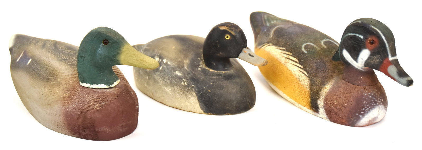 Three Wooden Duck Decoys: Mallard Drake, Bluebill Drake and Wood duck Drake, all with nice paint. Largest 7" H x 16" W. All in good condition.