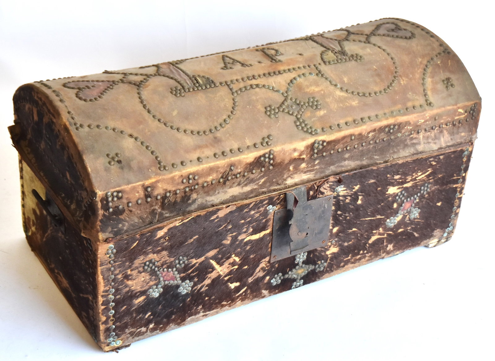 Early Tacked Cowhide Storage Chest: Circa 1830, with a great tacked design on top with hearts and initals A.P. 18" H x 36" W x 8" D. Fair condition.