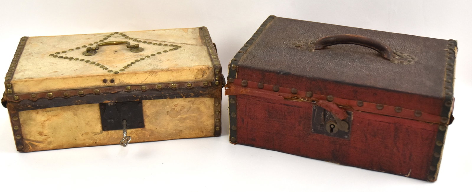 Two Early Tacked Document Boxes: First covered in cowhide with old red paint on front, top and back. 5 1/2" x 12" x 8"D. Good condition. Second covered in cowhide with brass handle. 4 1/2"H x 12" x 6 1/2". Good condition.