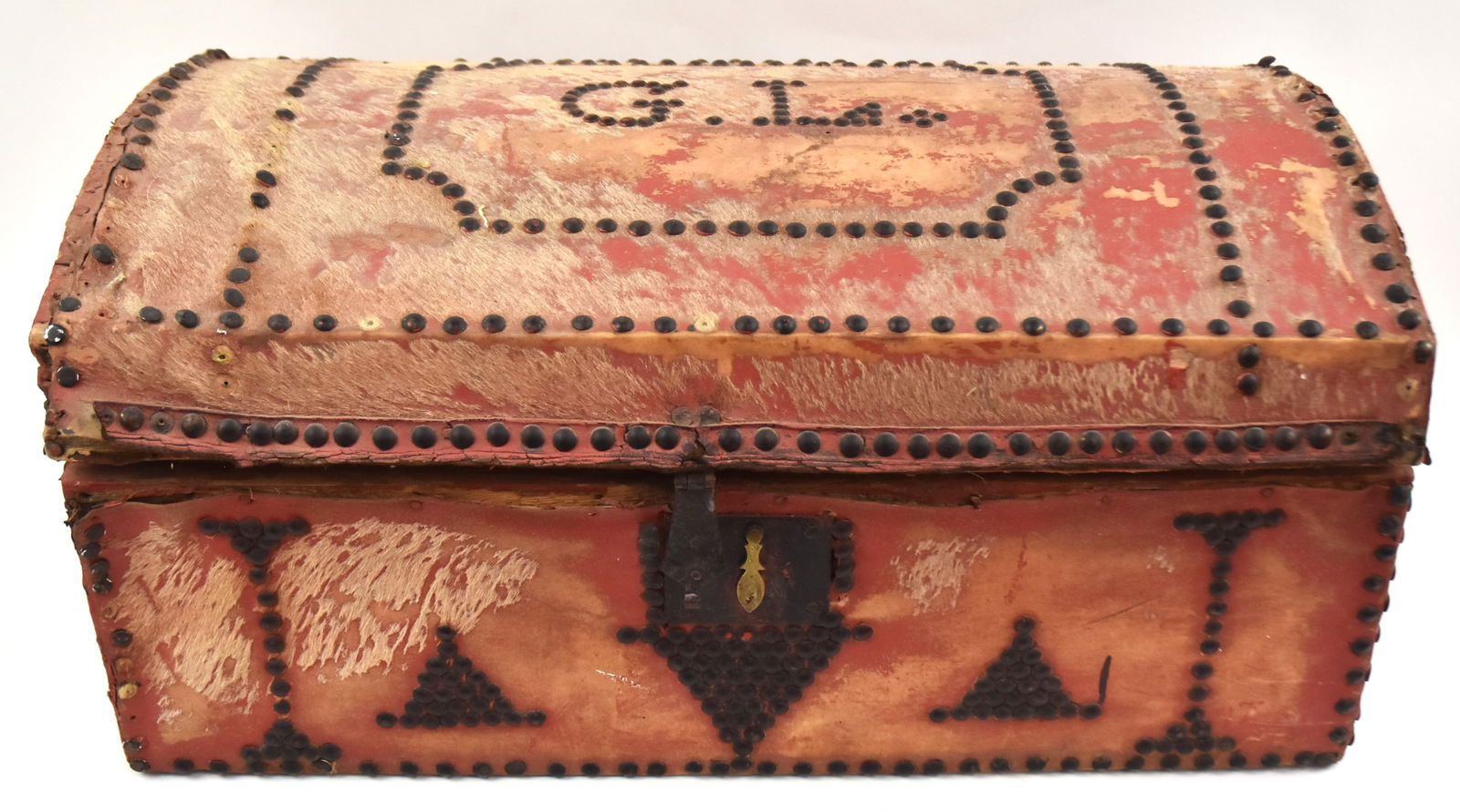Early Cowhide and Tacked Storage Box: With tacked "G. L." initials on top, and iron handles, with old red paint. Fair condition.