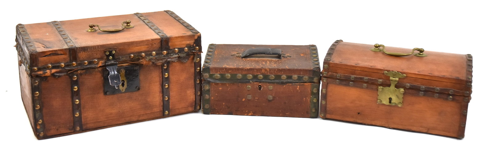 Three Early Tacked Document Boxes: First with dometop with brass handle, 5" H x 10" W x 6" D. Second leather covered with tacked edges and make-do leather hinge, 4" H x 8 1/2" W x 5 1/2" D. Plus a marked, "Amos Tappan" labeled box with