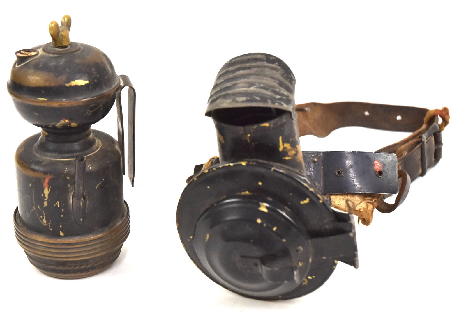 Two Miner's Lamps: First brass miner's head lamp with bullseye glass lens marked, "Brilliant Search Light," with leather strap, 6" H x 4" W. Second brass with hat clip, 6 1/2" H x 3" Dia. Both good condition.