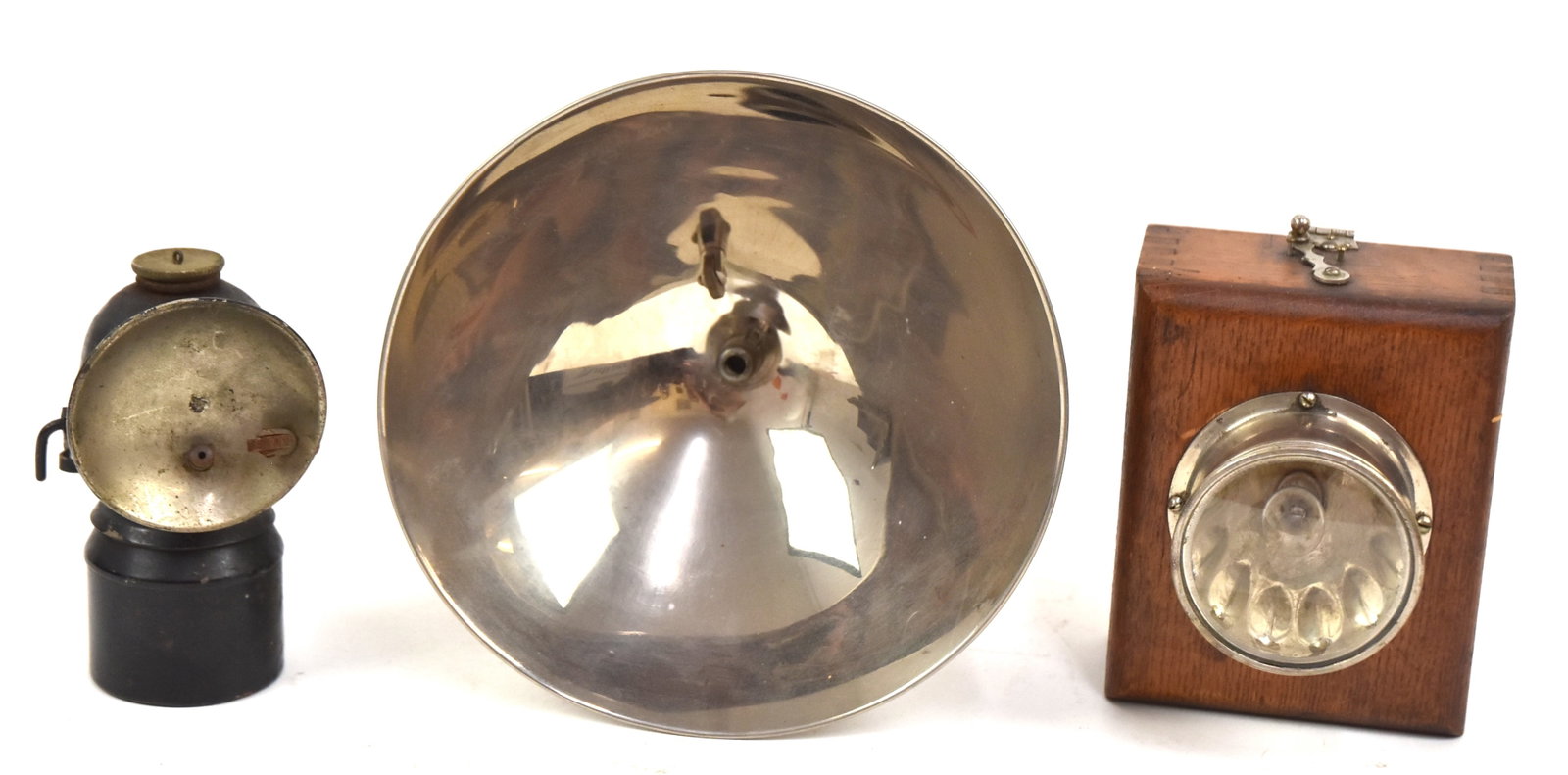 Two Miner's Lamps & Wooden Flashlight Lamp: First I oak case with sliding back door for batteries. Second tin carbine lamp with hat hook, 5" H, and a brass carbine miner's lamp with reflector marked, "Guys Droper." 7" H x 7" W. All in good cond