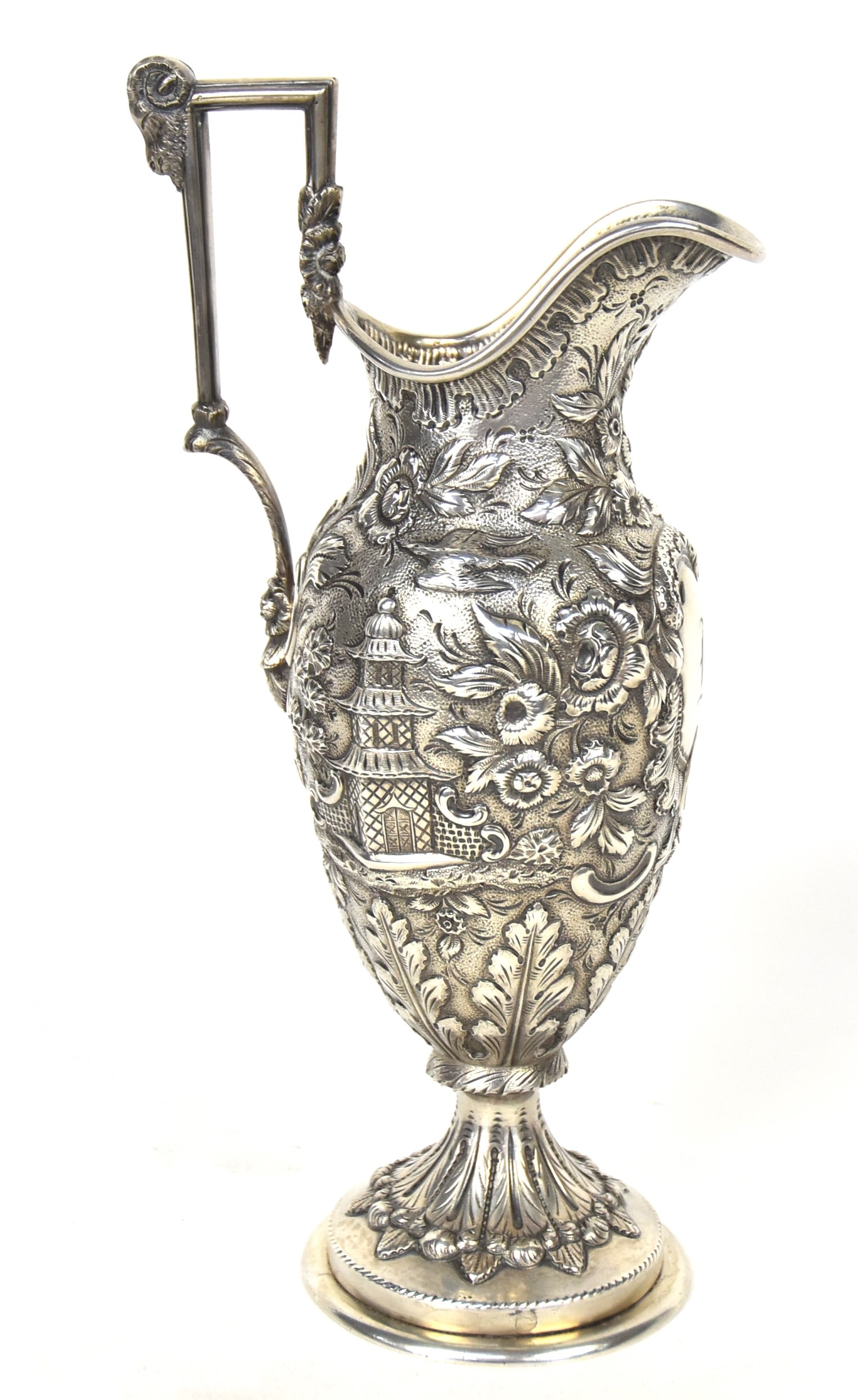 Fine Castle Pattern Chaised Silver Ewer: Wonderful pagodas, fountains & floral decoration and rams head handle. Marked with F and oval with lines plus.. 16.8 troy oz. 10"H. Good condition.