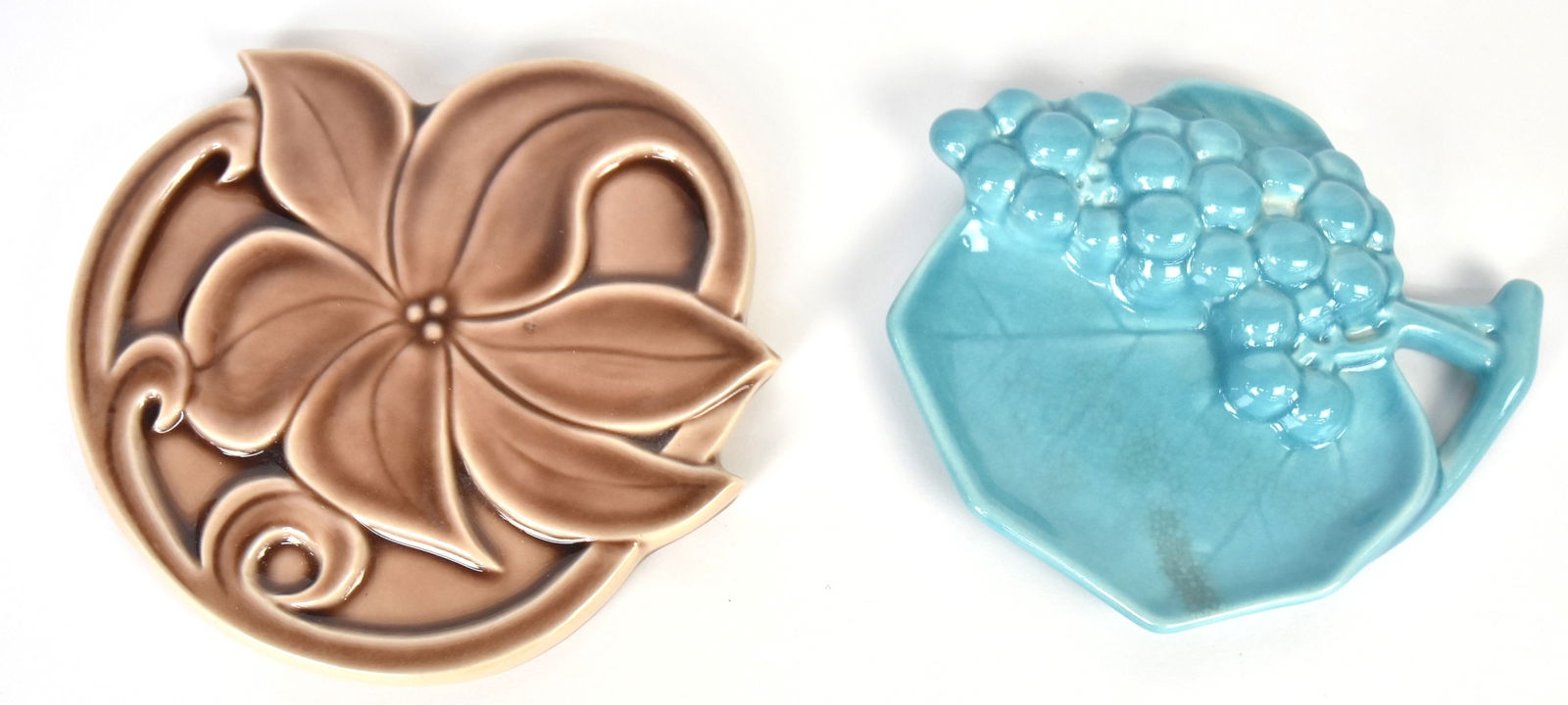 Rookwood Pottery Trivet and Tray: 1946 blue 7" W tray with raised grape designed by Shirayamadani. Good cond., 1954 trivet 7 1/4"W in brown glaze, has line on base.