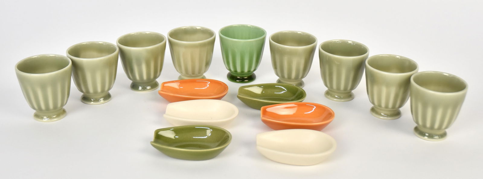 Nine 1933 Rookwood Pottery Egg Cups Plus: 2 3/4"H egg cups designed by Shirayamadani, plus six pipe holders dated 1965. All in Good cond.