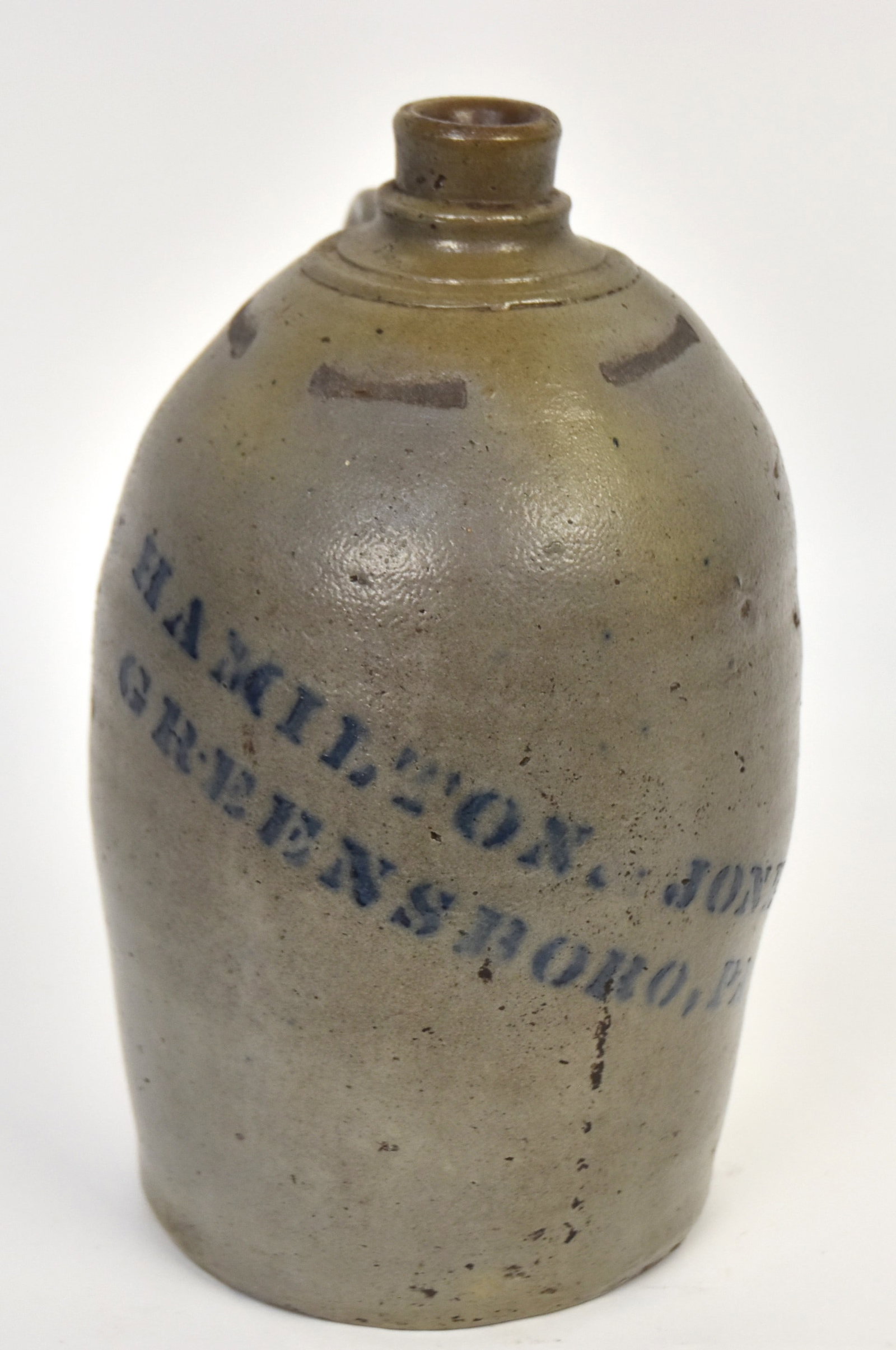 Hamilton & Jones Stoneware Jug: Blue stenciled Greensboro PA jug. Small factory flake to base otherwise good condition. 11 1/2"H.