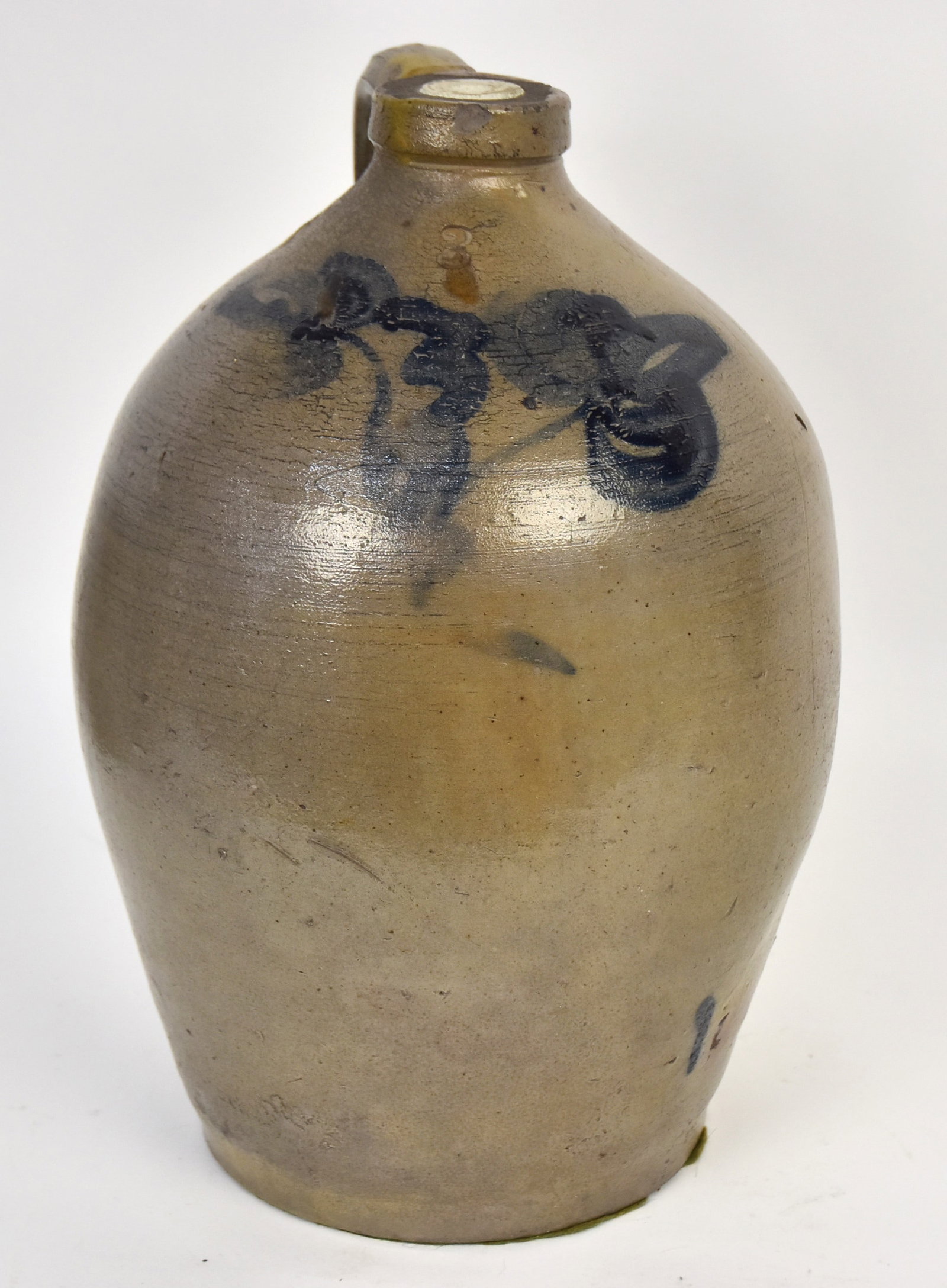 Blue Decorated Stoneware Jug: 3 gallon with double floral decoration. Very thin line at side towards base, small chip at rim and added plaster to top. 15"h.