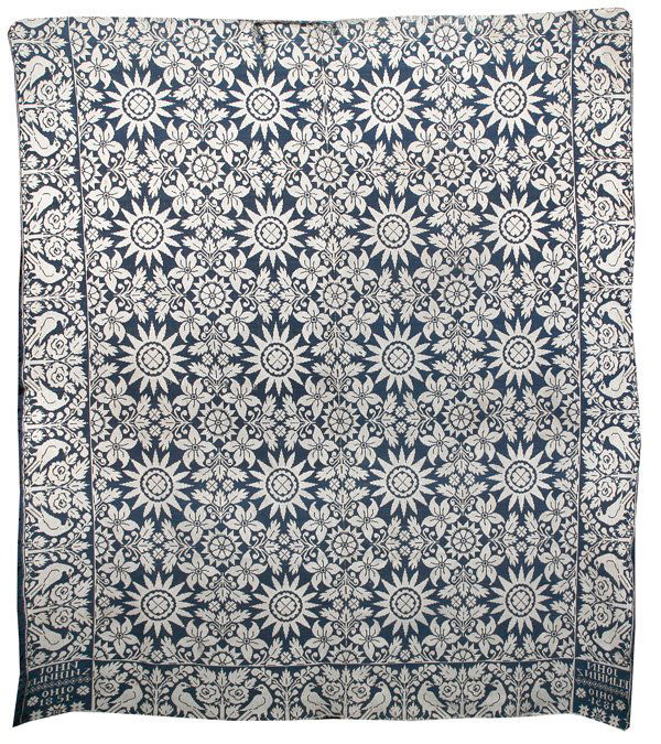 JOHN KLINHINZ, OHIO, 1851 JACQUARD COVERLET: Two piece blue and white bird borders with geometric and floral field. Two corner blocks with "John Klinhinz, Ohio 1851". Some wear. 86" x 70".