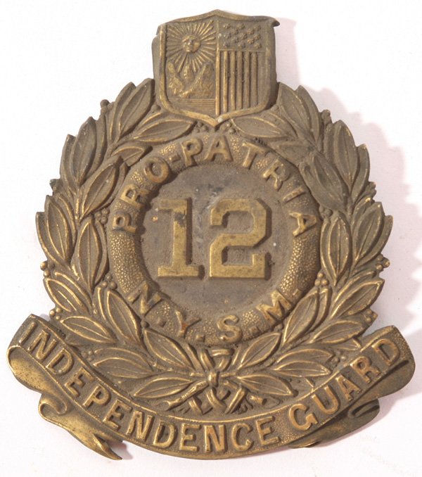 12TH N.Y. INFANTRY CIVIL WAR HAT BADGE: In stamped brass with original folding pins to attach to kepi. Good condition. 3 1/2" x 4 1/4" high.
