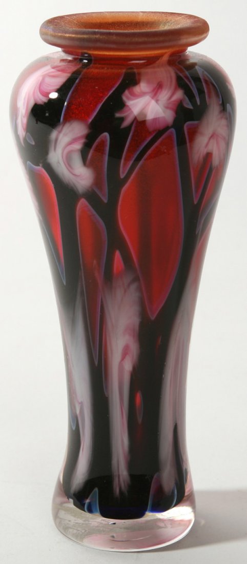 JOHN LOTTON FLORAL ART GLASS VASE: Decorated with opal pink florals mingling with ebony vines with a burgundy background and iridescent lip at top. Signed by "John Lotton" and dated 1991. Good condition. 7 1/4" h.