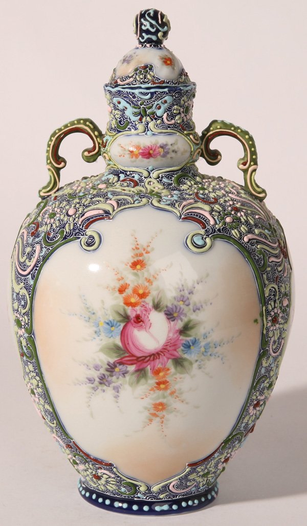 NIPPON HEAVY ENAMELED LIDDED URN: Wonderful multi-colored heavy floral enamel work with six hand painted floral panels. Damage to lid, otherwise fine condition. 9 1/4" h.