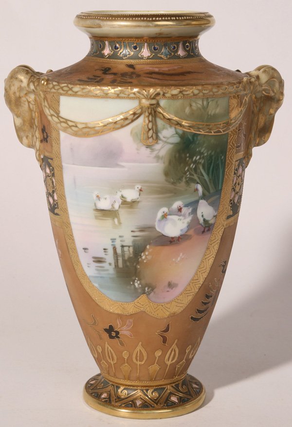 NIPPON HANDPAINTED VASE WITH SWANS: Rams head handles and nice enamel work. Slight gold wear at top, otherwise excellent condition. 11" h.