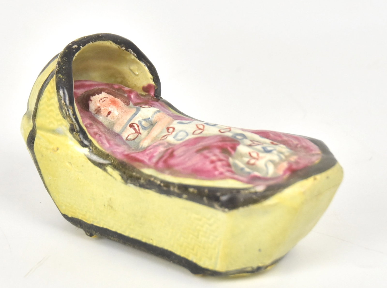 Early Staffordshire Pearlware Baby in Cradle: 2 1/2" H x 4 1/4" W. Good condition.