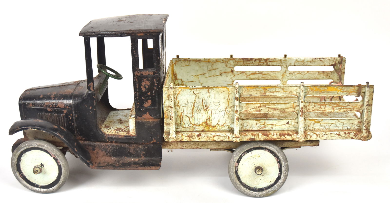 1920's Buddy L Pressed Steel Baggage Line Track: With painted Buddy L. decal on floor board, with stearing wheel. Old kid repaint with yellow showing through on bed. 12" H x 26" W. As above, structurally good condition.