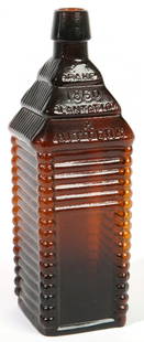 AMBER ST. DRAKES 1860 PLANTATION BITTERS BOTTLE: In the form of a log block house, Fine condition. 10" h.