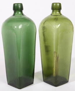 TWO GREEN GIN BOTTLES: Coffin shaped and vertically ribbed. Fine condition. 9" h.