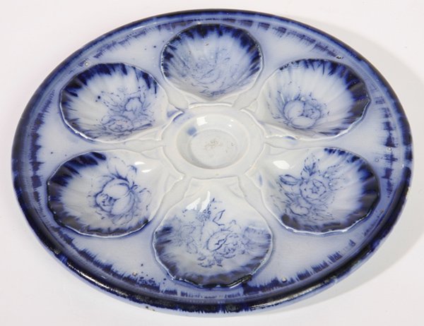 EARLY FLOW BLUE OYSTER PLATE: Floral decoration. Marked "Ironstone, Staffordshire, England" on base. Excellent condition. 10 1/4" w.