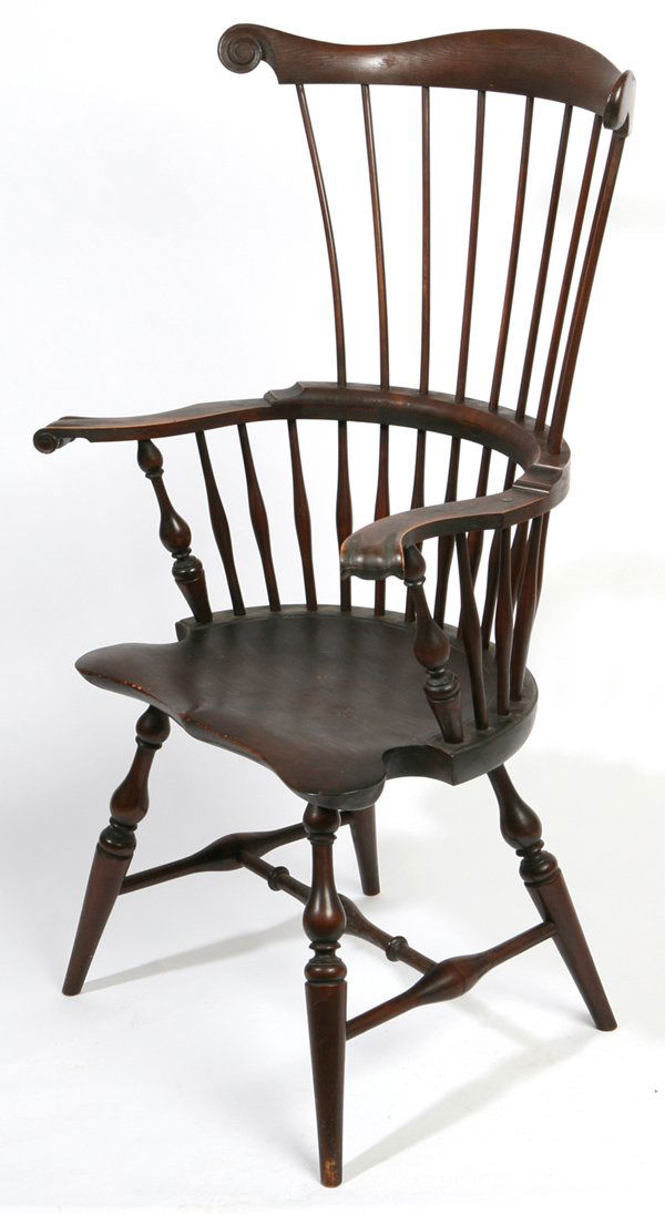 WALLACE NUTTING FANBACK WINDSOR CHAIR: With wonderful saddle shaped seat, tapered turned spindles, scrolled carved ears, and graceful turned legs and stretchers. With "Nutting" paper label on underside of seat. Original finish. Fine condit