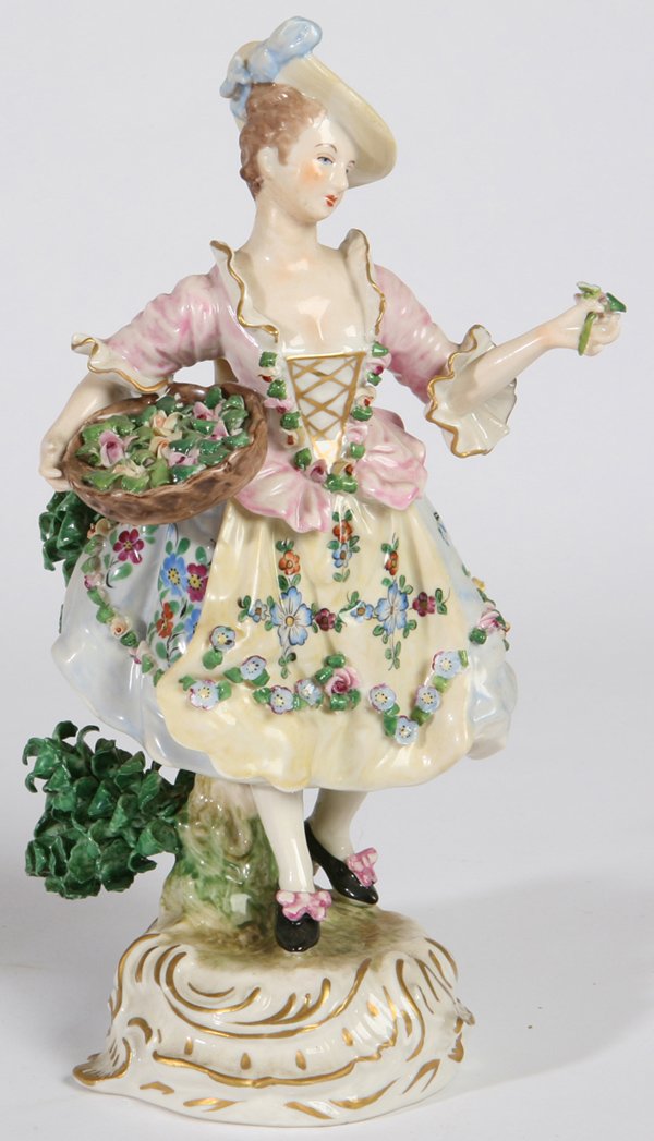 CAPODIMONTE PORCELAIN FIGURE OF FLOWER SELLER: Finely painted with basket of flowers, blue under glazed crowned "N" on base. Fine condition. 10" h.